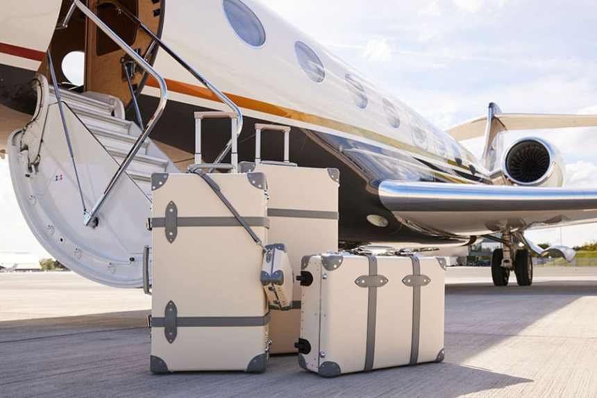 Private jet with luxury luggage awaiting boarding