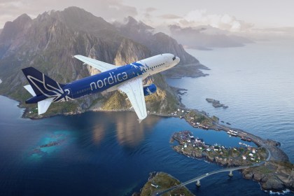 Estonian Nordica aircraft flies over sea and mountains