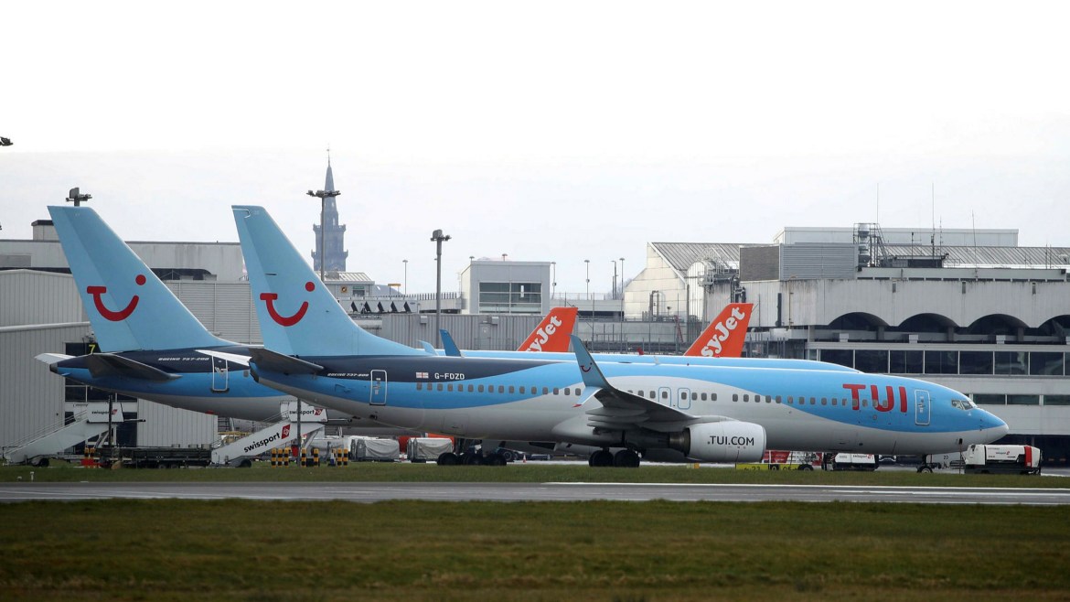 TUI 737-800 parked at on stand at Manchester Airport 