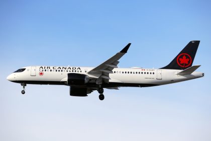 Air Canada A220 flying in a blue sky