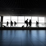 Passengers walking through an airport.