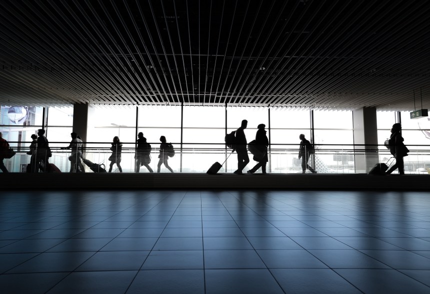 Passengers walking through an airport.