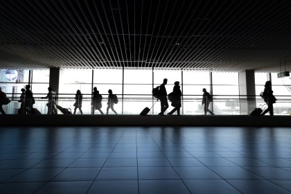 Passengers walking through an airport.