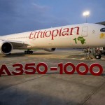 An Ethiopian Airlines Airbus plane behind an A350-1000 sign