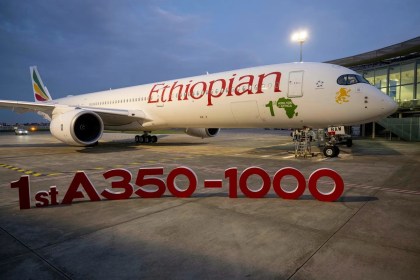 An Ethiopian Airlines Airbus plane behind an A350-1000 sign