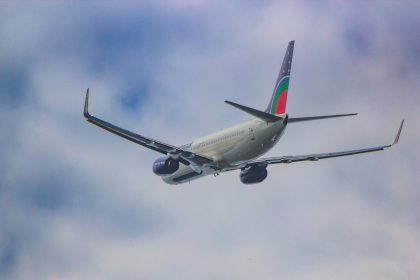 a large jetliner flying through a cloudy blue sky