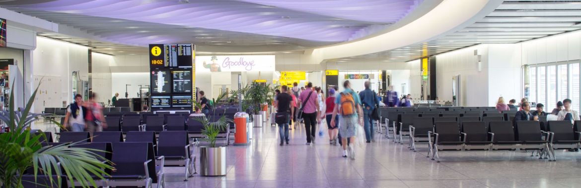 People walk through an airport