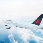 Aerial in-flight view of Air Canada Boeing 787 Dreamliner flying high above the clouds.