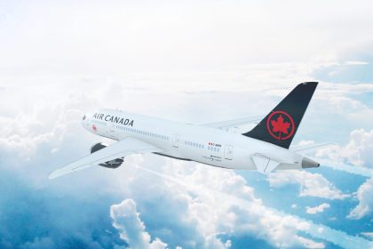 Aerial in-flight view of Air Canada Boeing 787 Dreamliner flying high above the clouds.