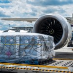 Air cargo logistic containers are loading to an airplane. Air transport shipment prepare for loading to modern freighter jet aircraft at the airport.