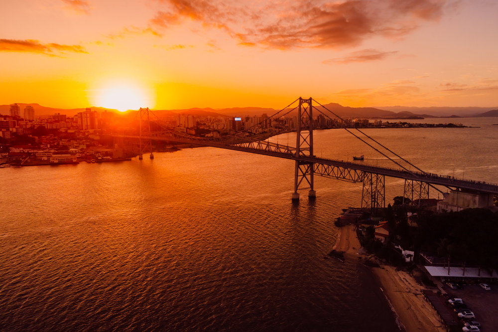 Remove BG Save Share Sample Old cable bridge with sunset in Florianopolis, Brazil. Aerial view