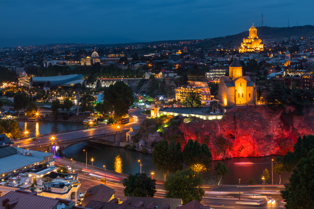 Tbilisi, Georgia - 30 August 2018: Cityscape Skyline In Night Illumination With Famous Landmarks. Rike Park, Holy Trinity Cathedral Or Sameba, Saint George Armenian Cathedral, Metekhi Church