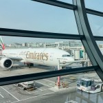 DUBAI, UAE. 16 SEPTEMBER 2023. In departure, view through glass: Boeing 777, passengers boarding, a prelude to the imminent journey