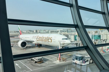 DUBAI, UAE. 16 SEPTEMBER 2023. In departure, view through glass: Boeing 777, passengers boarding, a prelude to the imminent journey