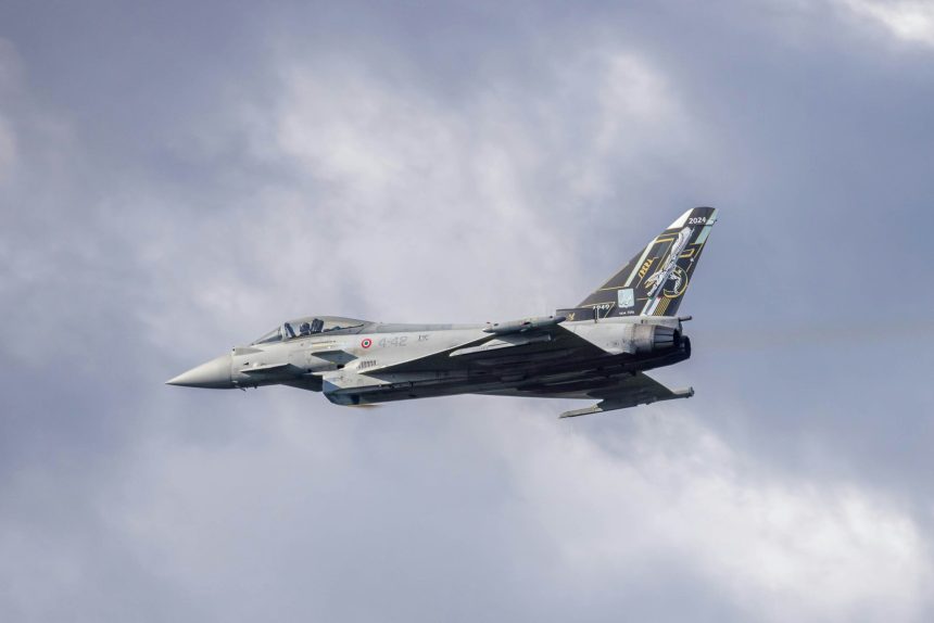 A jet flying against the clouds.