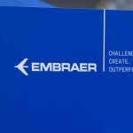 Blue Embraer logo and slogan