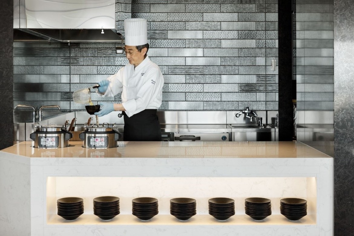 A chef in the kitchen of Delta's Sky Club