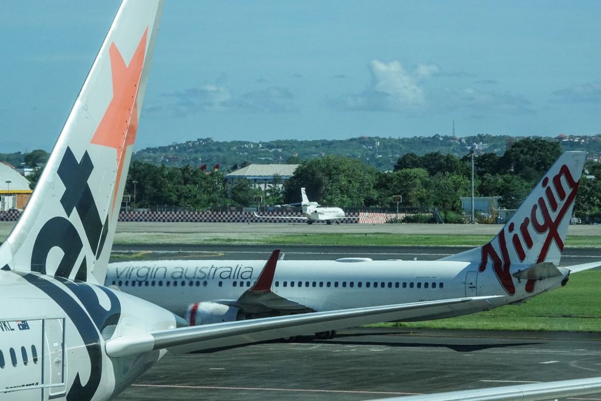 A Jetstar and Virgin Australia plane on a tarmac