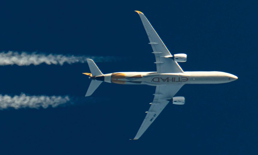 An Etihad plane flies in the sky