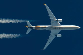 An Etihad plane flies in the sky