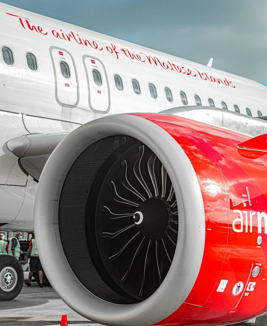 Red and white Air Malta aircraft with writing "The airline of the Maltese islands"