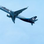 Blue and White Alaska Airlines Plane flying in the sky