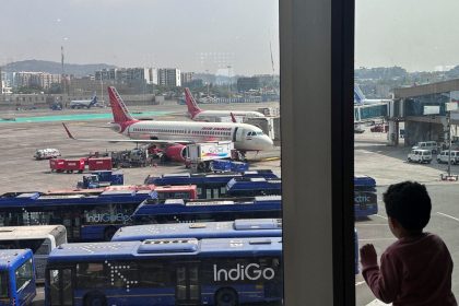 A boy looks at aircraft in an airport