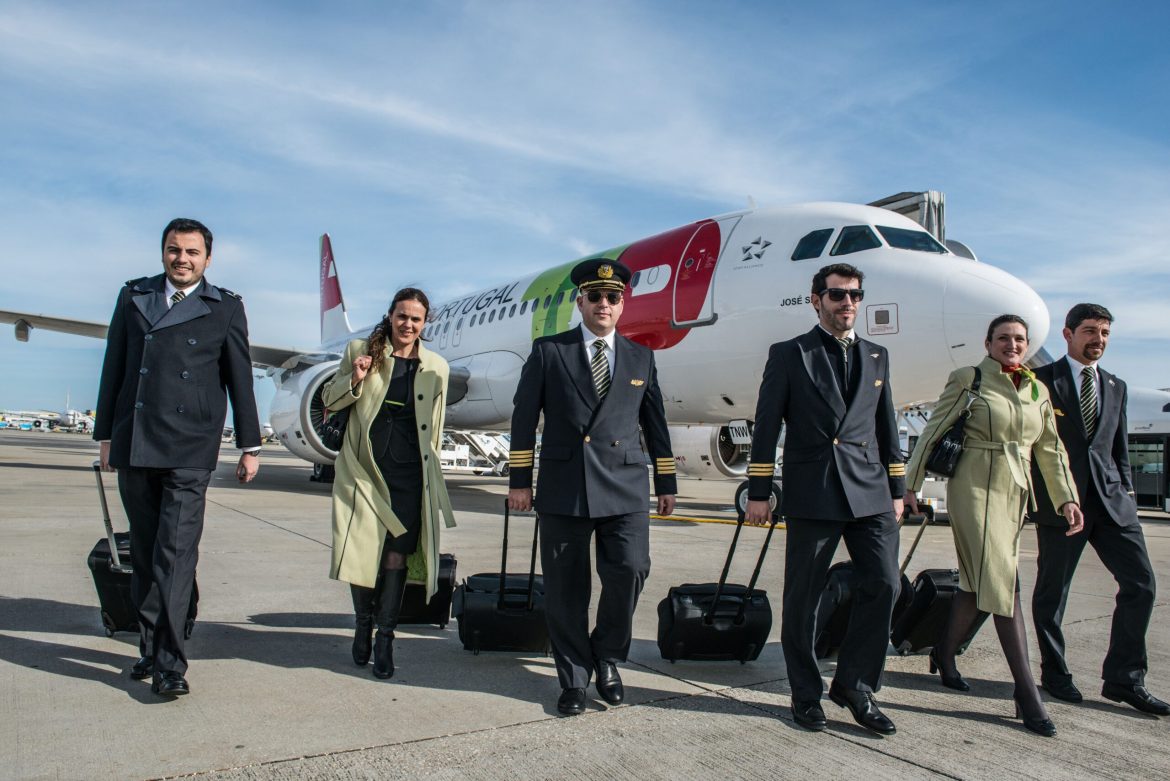 TAP Air cabin crew standing infront of the aircraft